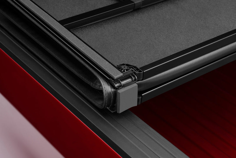Lund 04-15 Nissan Titan (5.5ft. Bed) Hard Fold Tonneau Cover w/Bracket Kit - Black