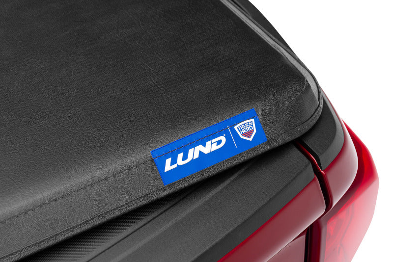 Lund 04-15 Nissan Titan (5.5ft. Bed) Hard Fold Tonneau Cover w/Bracket Kit - Black